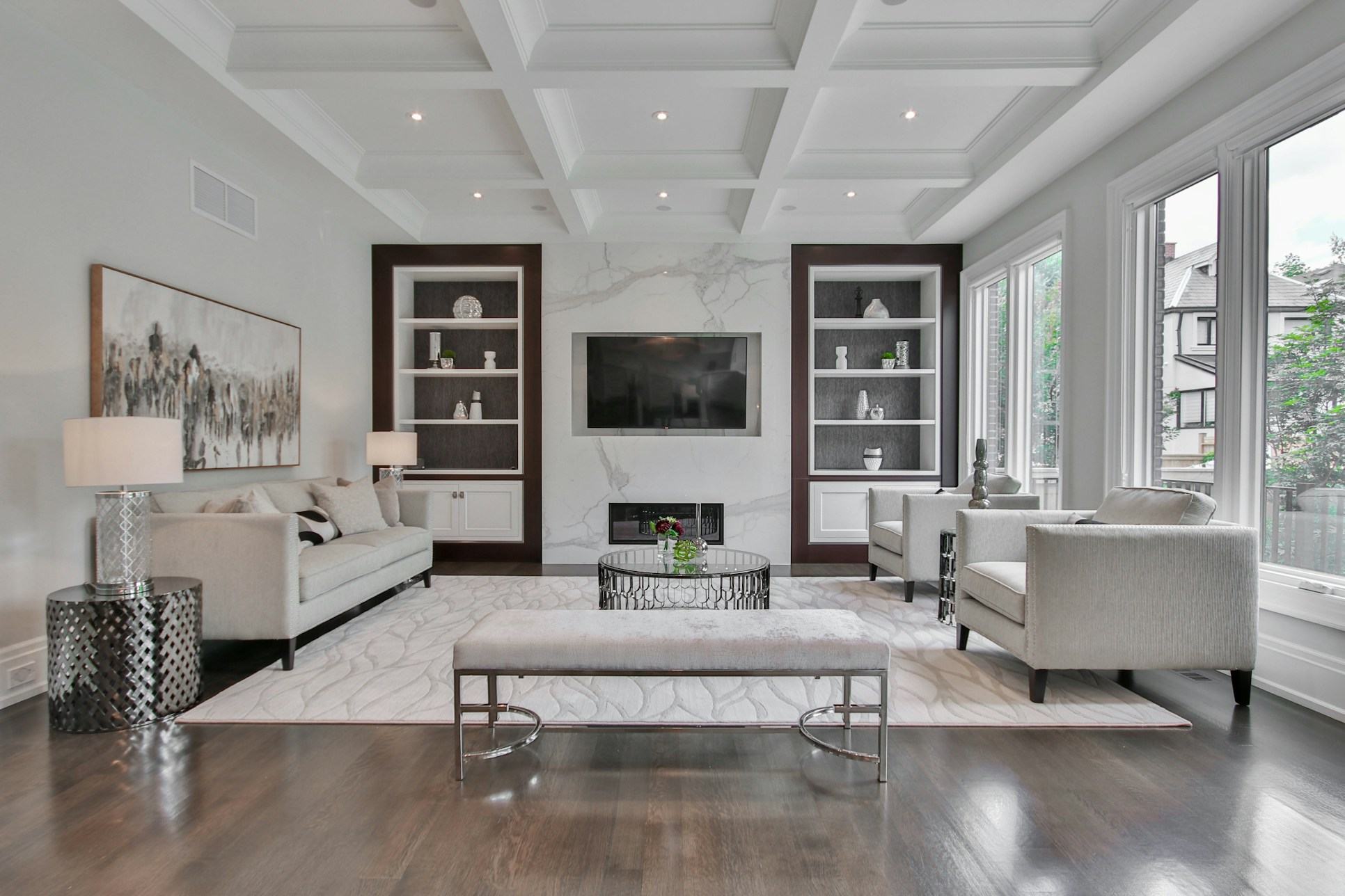 Formal lounge with coffered ceiling, marble fireplace and built-in shelving