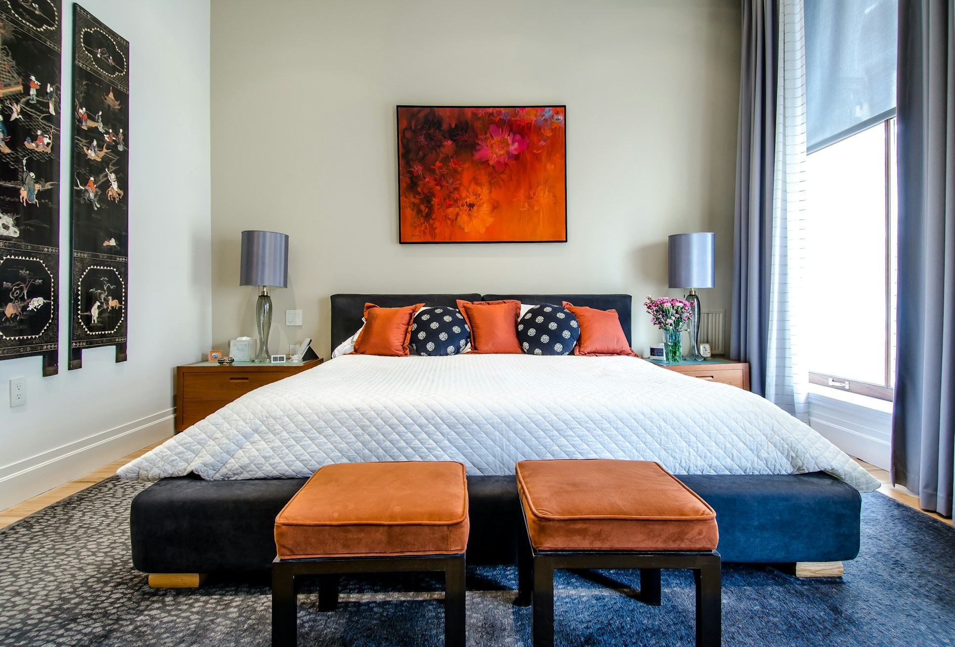Master bedroom with king bed, bench seating and large window