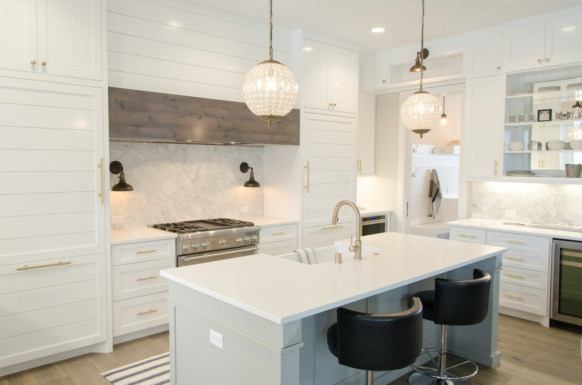 White shaker kitchen with island seating and pendant lighting